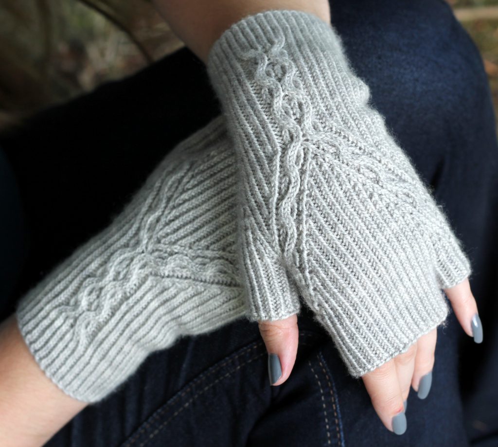 Twisted Rib fingerless mitts with a cable up the centre of the back of the wrist and splitting to either side of the hand