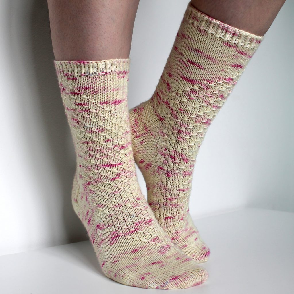 Speckled socks with a wide diagonal stripe with a textured pattern mirrored across each foot